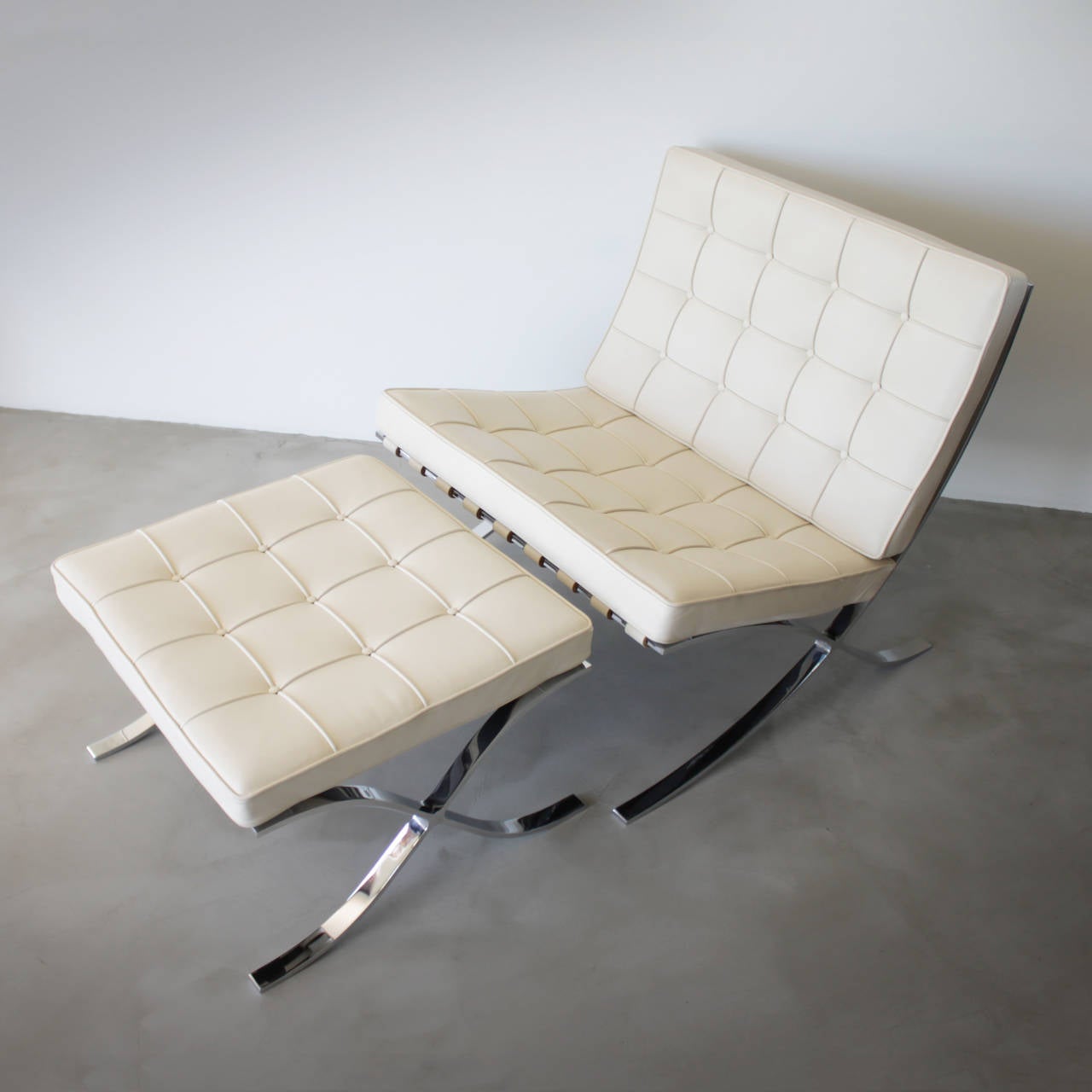 Original off white Barcelona chair with ottoman by Ludwig Mies van der Rohe for Knoll International. The No. MR90 designed for the German Pavilion at the 1929 World Exhibition Barcelona. Bent chromed flat steel frame with leather straps and buttoned