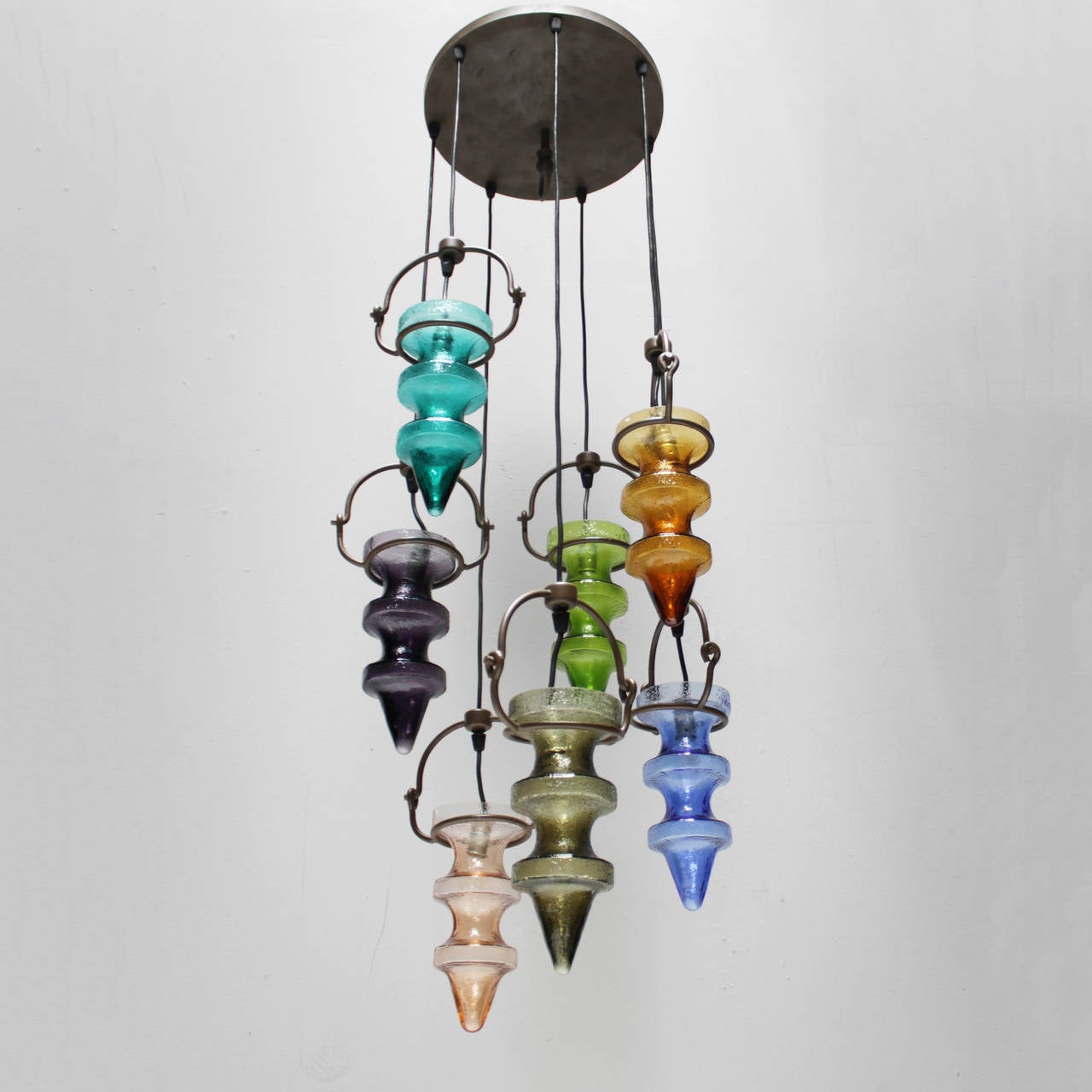 Chandelier stalactites with seven colorful glass pendants by Nanny Still-McKinney for RAAK Amsterdam. Beautiful condition.

Nanny Still McKinney (1926-2009) studied at Finland’s Central School of Arts and Crafts in Helsinki. Already before her