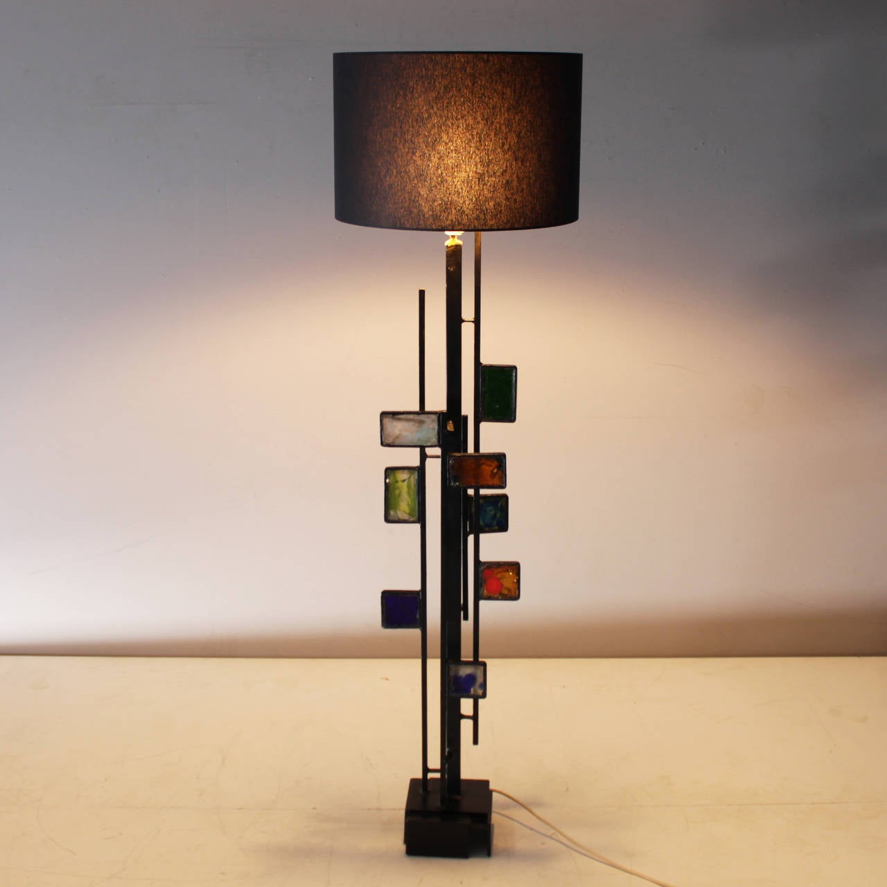 Beautiful rare floor lamp in the style of Svend Aage Holm Sorensen. 
Geometric shaped with colorful glass mosaic. Black lacquered steel base. Rewiring is strongly recommended. 
Height from base till top socket 44.3 in. (112.5 cm), width 9.0 in.