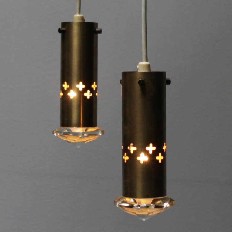 Beautiful pair of small pendant lights from Sweden. Solid faceted glass with brass fixture. Design in the manner of Gino Sarfatti.
Measurements: height 5.9 in. (15 cm), diameter glass 2.5 inches (6,3 cm).