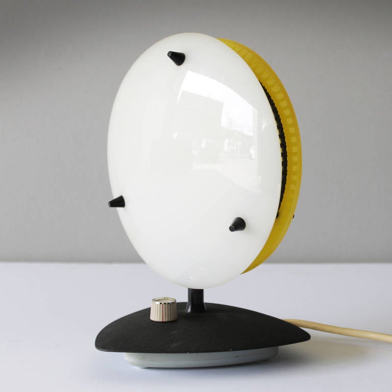 This rare and little table lamp might be a product of Arredoluce, and could be designed by Angelo Lelli or Ettore Sottsass. Though the light is unmarked, it bears a number of characteristics of this well known Italian company. The lamp is executed