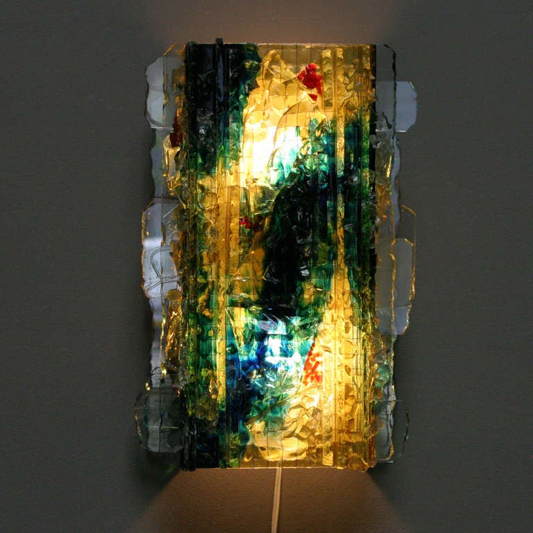 Glass Sconce 'Chartres' by A. Lankhorst for Raak Amsterdam.
Wall lamp with stained glass fusing panel at the front and sides.

Measurements: height 15.7 in. (40 cm), lenght 9.8 in. (25 cm),
depth: 4.5 in. (11,5 cm).

Please ask me for the