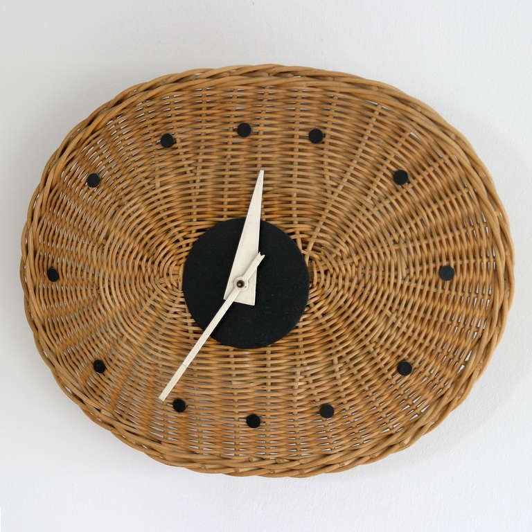 Basket Oval Clock 2216 by George Nelson for Howard Miller Clock Company, Zeeland Michigan. Wicker dial.
Measurements: diameter 12.9/11.0 in. (33/28 cm), depth 2.8 inches (7cm). Original electric clock (115V/60Hz).

Literature: George Nelson,