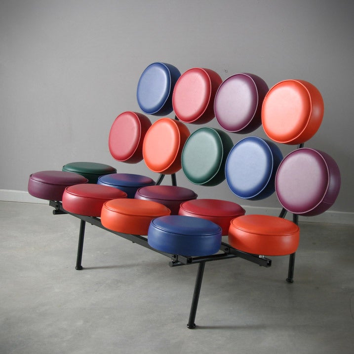 A pair of George Nelson Marshmallow Sofas for Vitra. Colored naugahyde vinyl cushions on a structured base of stainless steel and black lacquer. They are about 10 years old.