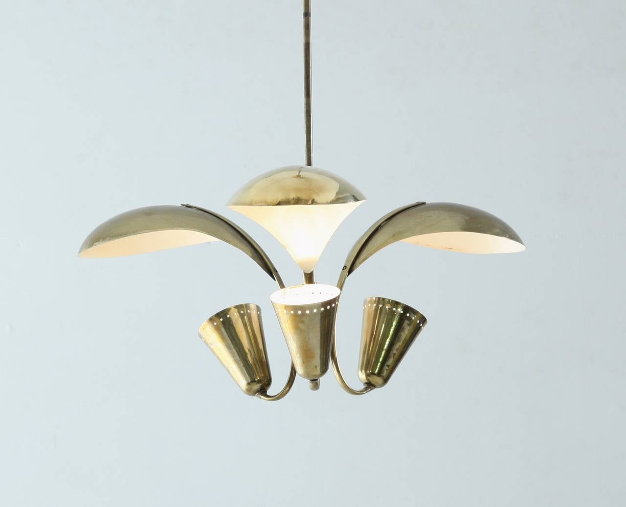 A three armed brass Paavo Tynell chandelier for Idman, with beautiful indirect light, as a result of the large petal-shaped deflectors.
