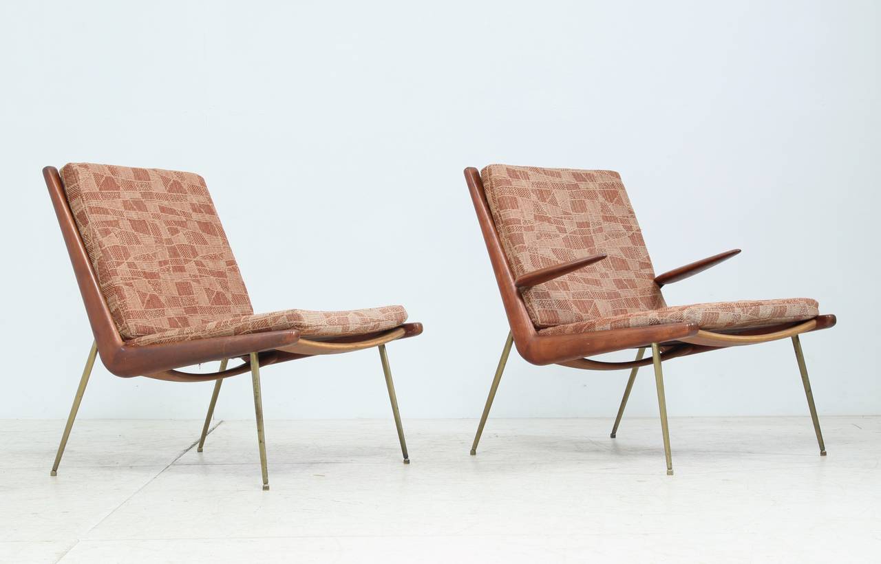 A pair of FD 134 'Boomerang' chairs by Peter Hvidt & Orla Mølgaard Nielsen for France & Daverkosen. These chairs are made of teak with brass legs and cushions with the original patterned brown upholstery. One of the chairs has brass and teak