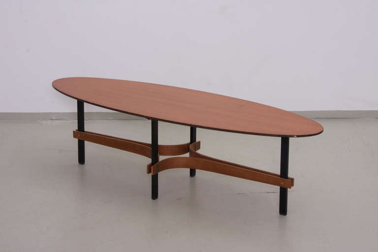 Elegant large italian surfboard shaped coffee table with nice brass details and plywood. Teak top with some scuffs and wear of age. Teak top!