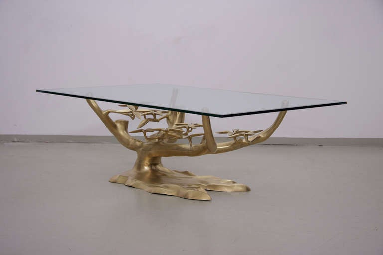 Rare brass coffee table attributed to Willy Daro with thick glass top and heavy brass base with natural leaf details. Glass top has a chip at corner. Base is excellent!