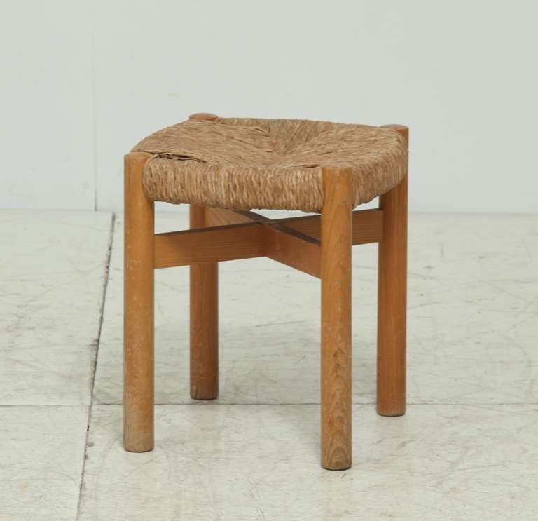 A four-legged stool with reed seating by Charlotte Perriand, designed for the chalet-hotel Le Doron in the French ski resort Méribel Les Allues, built (1946-48) by architects Paul Grillo and Christian Durupt and furnished by Perriand.