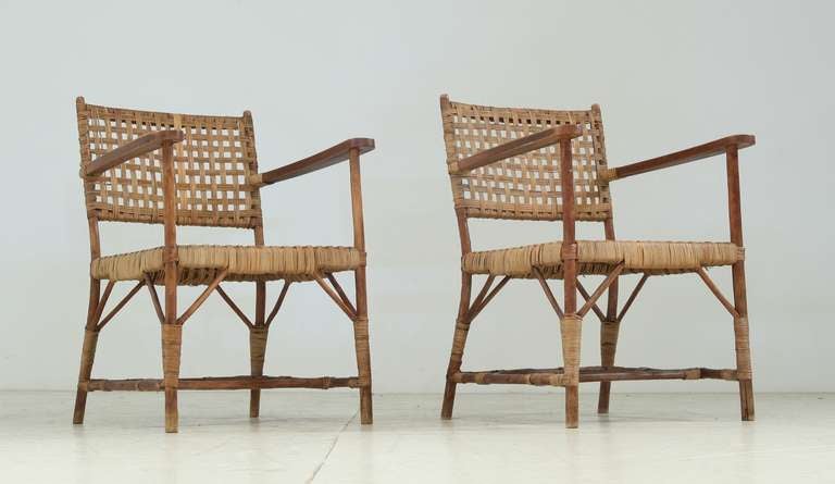 Pair of chairs made of willow, cane and leather.  Light in weight and appearance. Made with materials available at the time, in excellent condition.