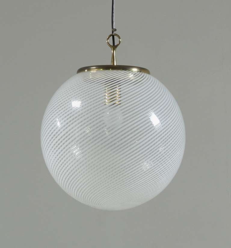 Glass ball pendant by Venini with white swirls.
Total drop is adjustable to your requirements.