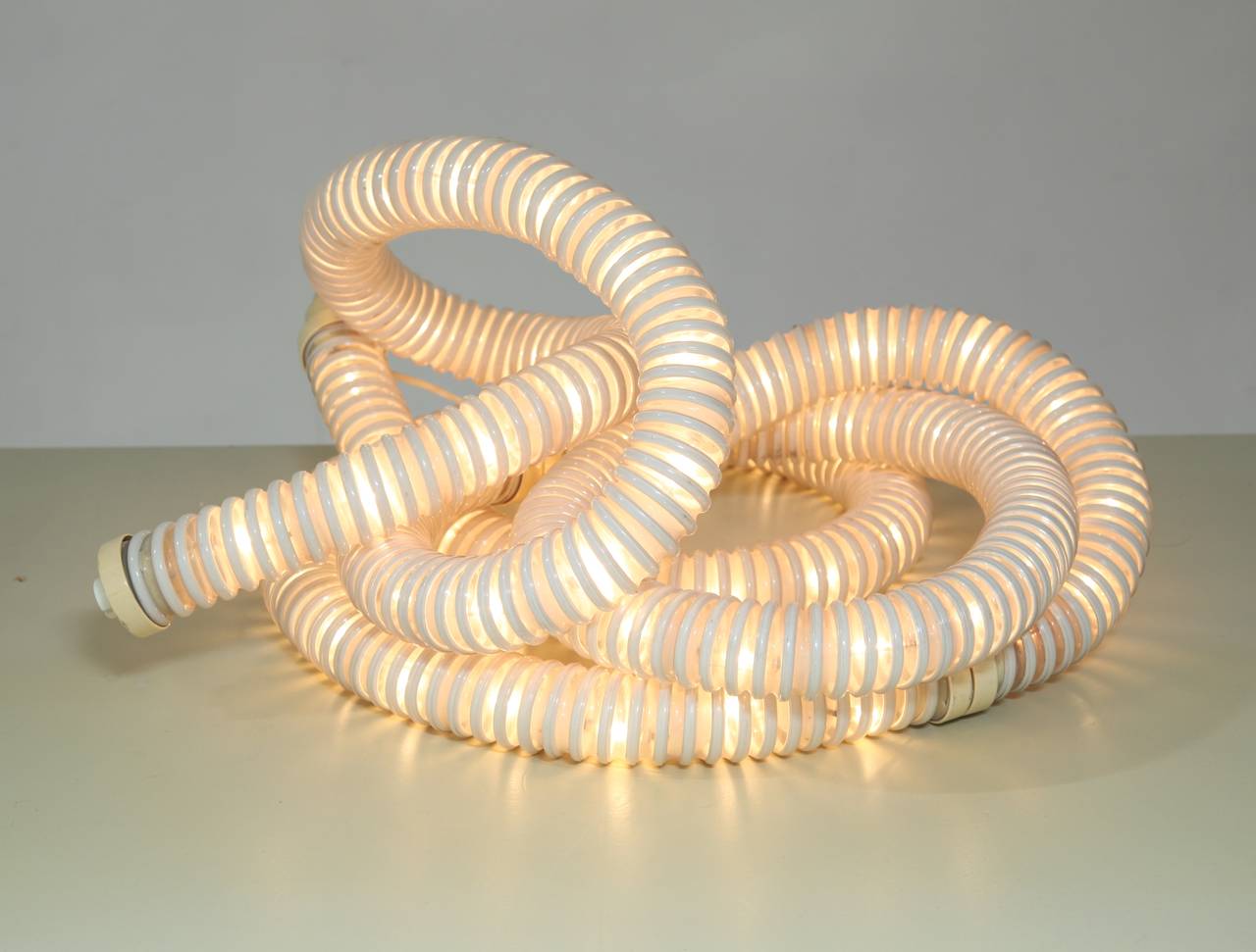 A 'Boalum' lamp, designed by Gianfranco Frattini and Livio Castiglioni for Artemide in 1971. The boa constrictor inspired lamp is made of a flexible plastic tube that can be shaped anyway you want and can be used on a table, the floor, wall or