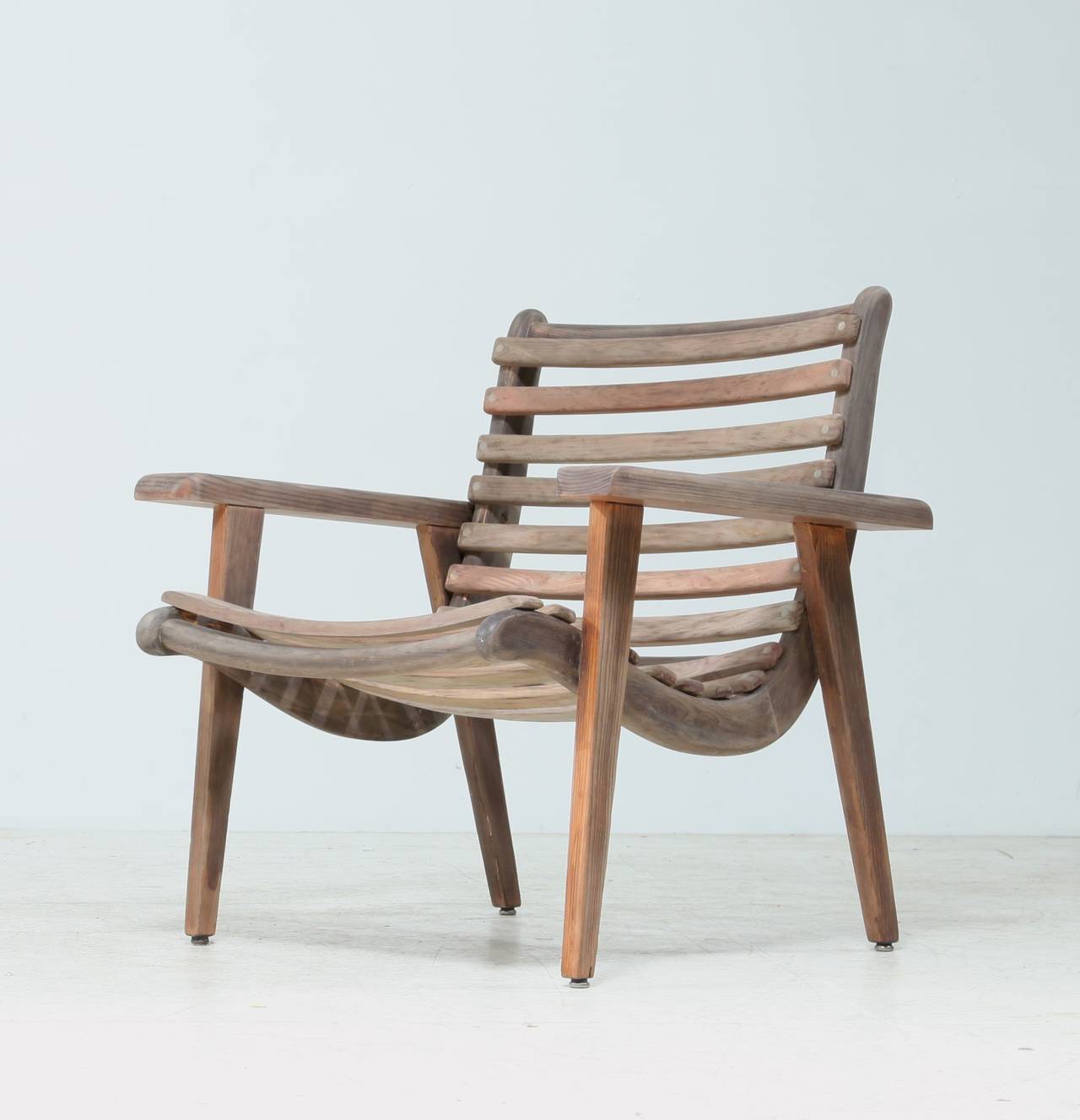 A 1950s easy chair by Michael van Beuren for Domus, Mexico.
The chair has a tropical wooden frame with darker slats. In a wonderful, original condition and labeled by Domus.

Bauhaus trained Van Beuren moved to Mexico in the 1930s, where he