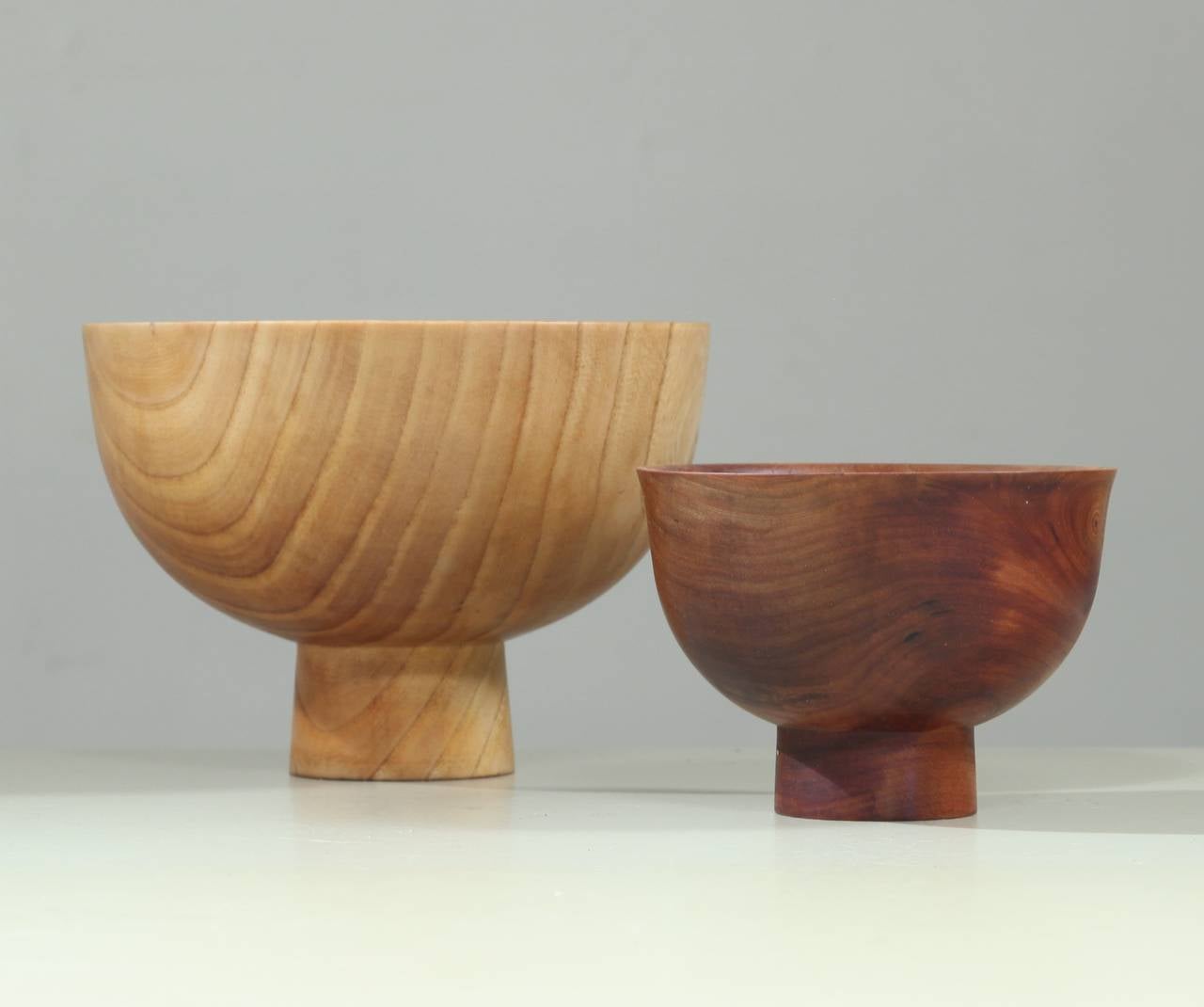 A pair of two wonderful turned bowls by American Woodworker Ed Miller.
Both items are signed with 'E.M.,' with the year they were made.

The largest bowl (1972) is made of a light wood with a beautiful grain and is 13.5 cm high, with a diameter