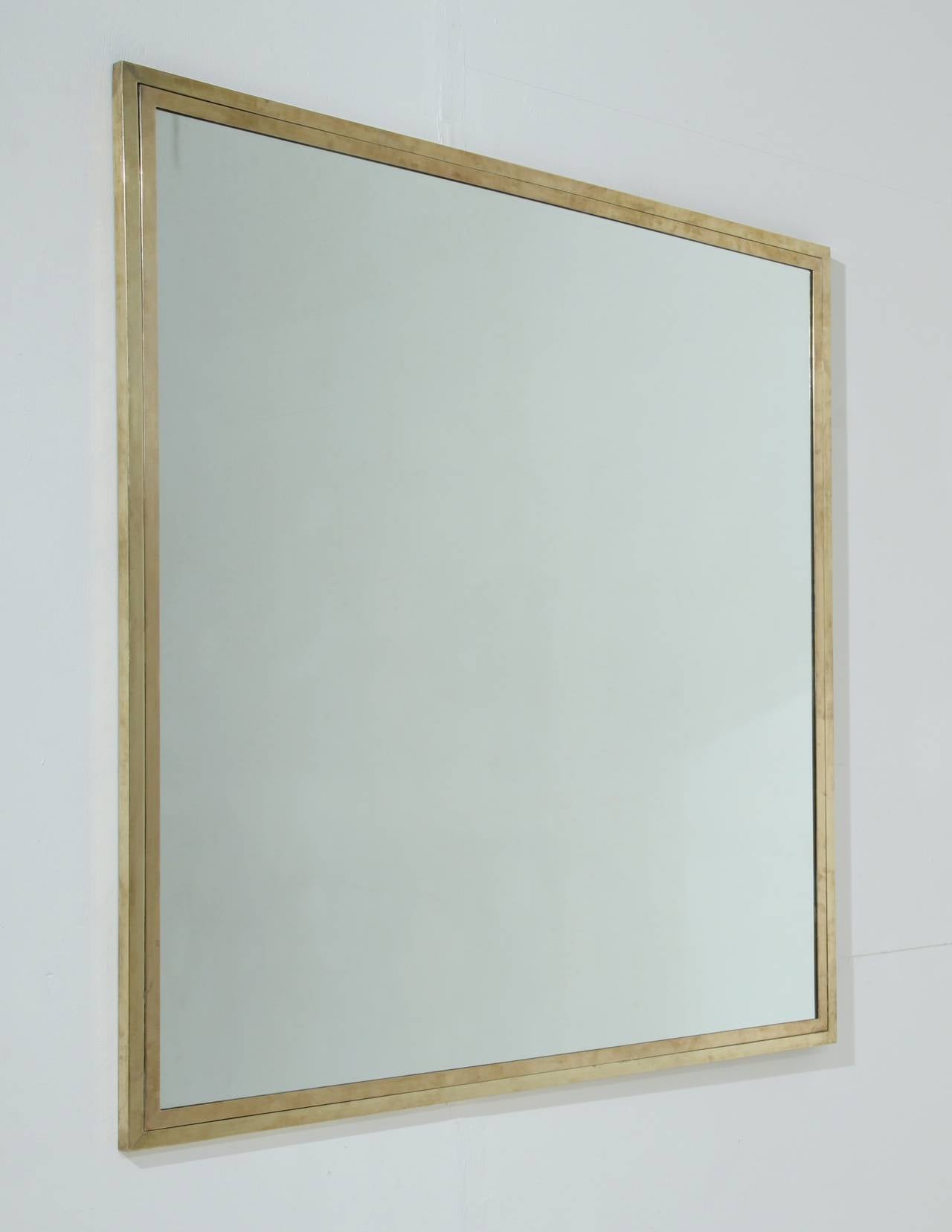 This simple and elegant mirror has a double brass frame. The brass has a mild patina from age.

We have several 1950s brass framed mirrors available in various models and sizes. Please contact us for more details.