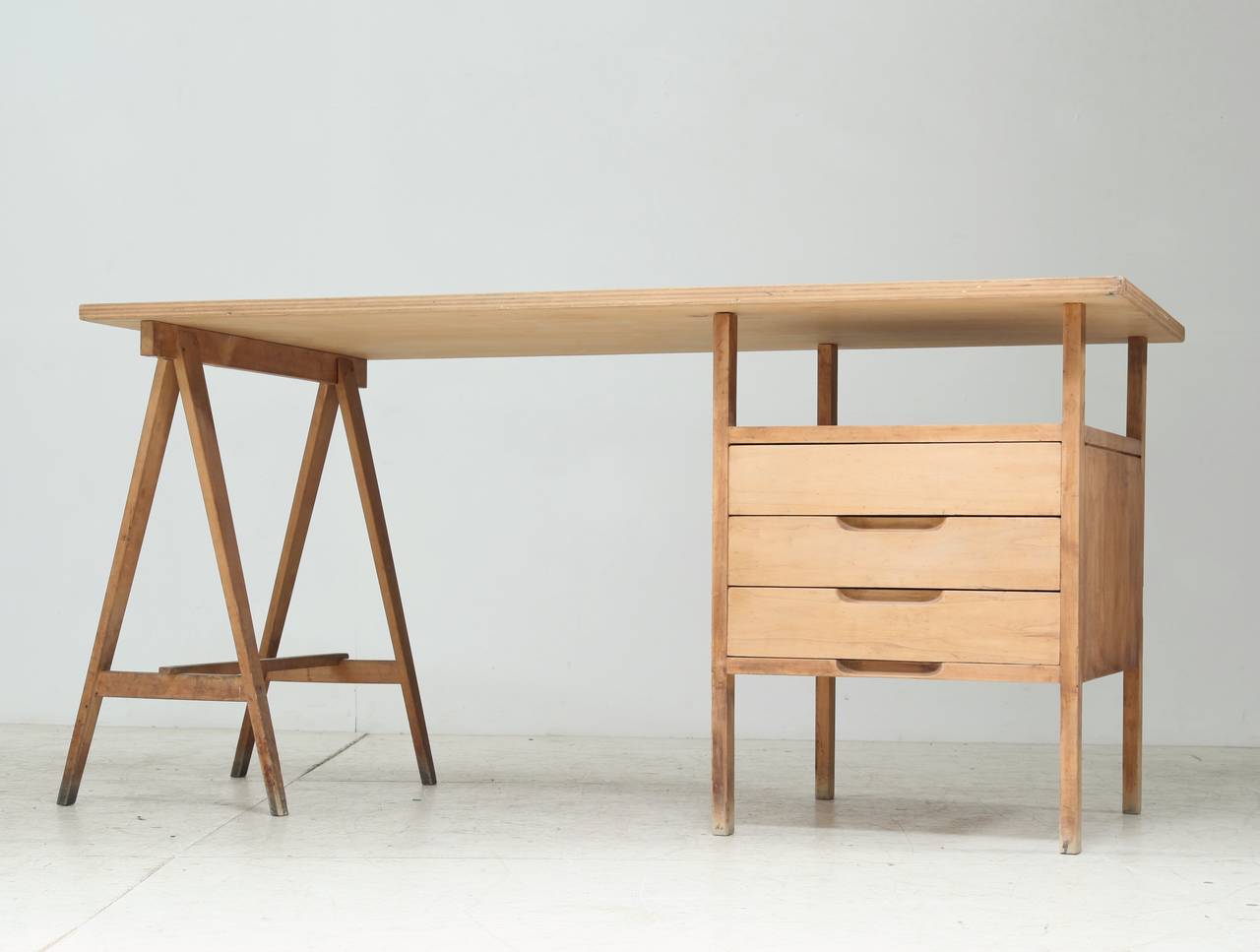 A very rare Angelo Mangiarotti wooden studio desk. The top of this wonderful and functional desk rests on a trestle and a storage unit with three drawers. 
This desk was designed by Mangiarotti for and used in his Via Cappuccio studio in Milan,