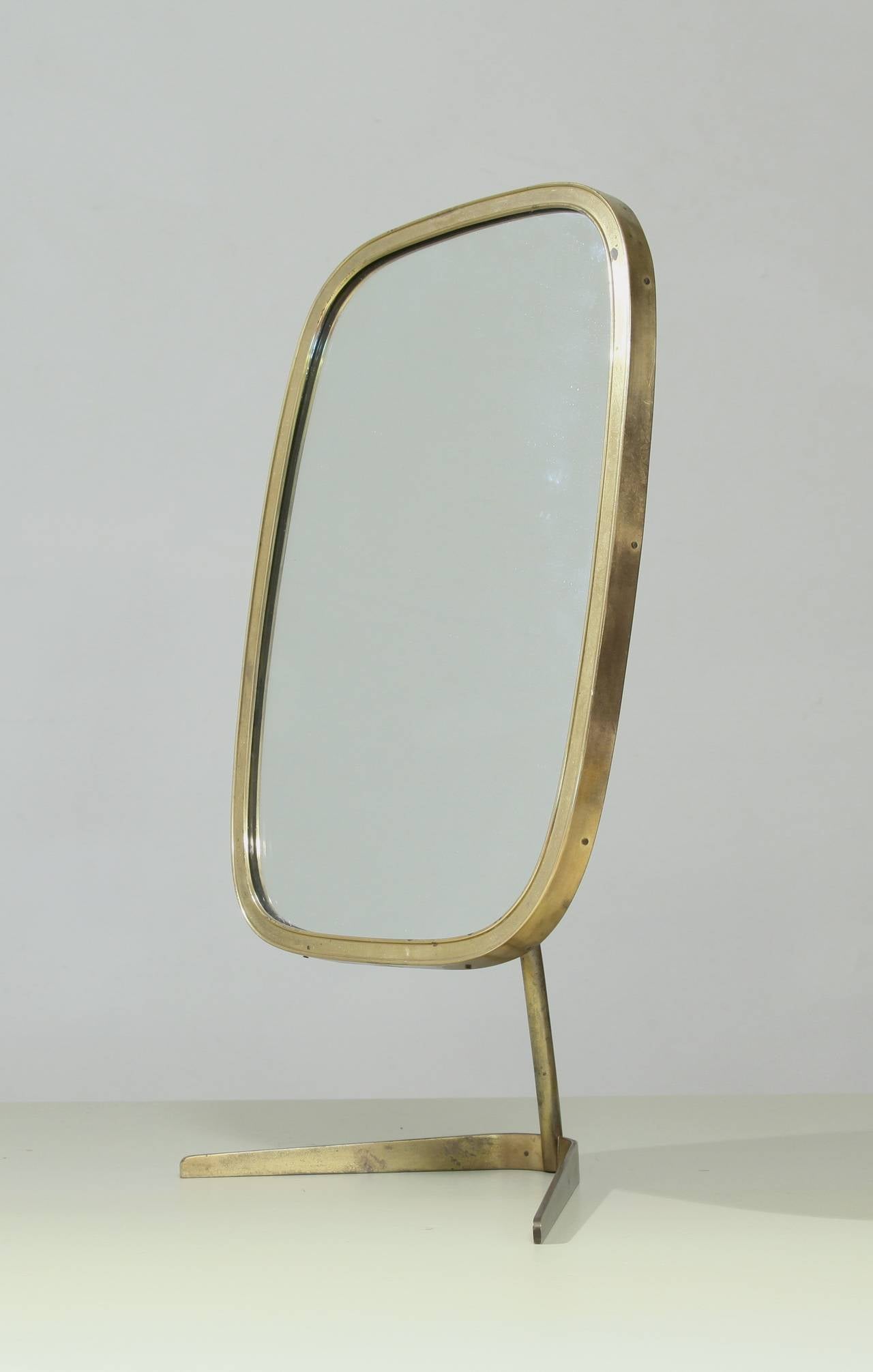 A beautiful Italian vanity mirror with a rounded, rectangular frame and standing on a crow's foot. Simple and beautiful.
.