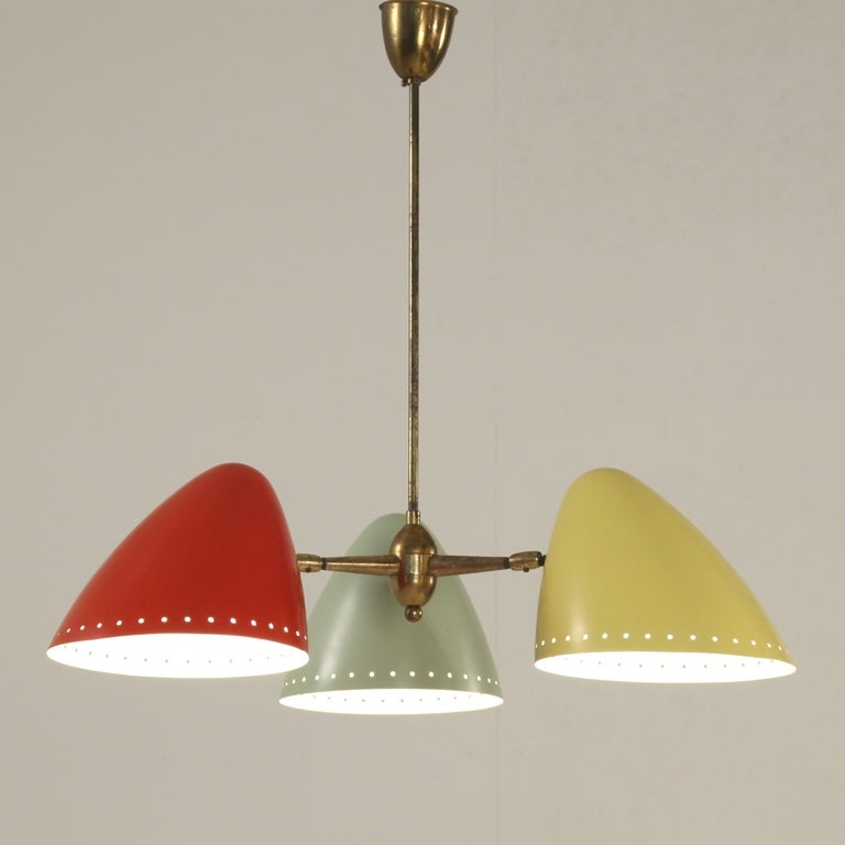 Italian 1960s Stilnovo chandelier with 3 coloured shades that can be used boths as uplight as well as spotlights facing down. Beatiful red, yellow and pale green combination.