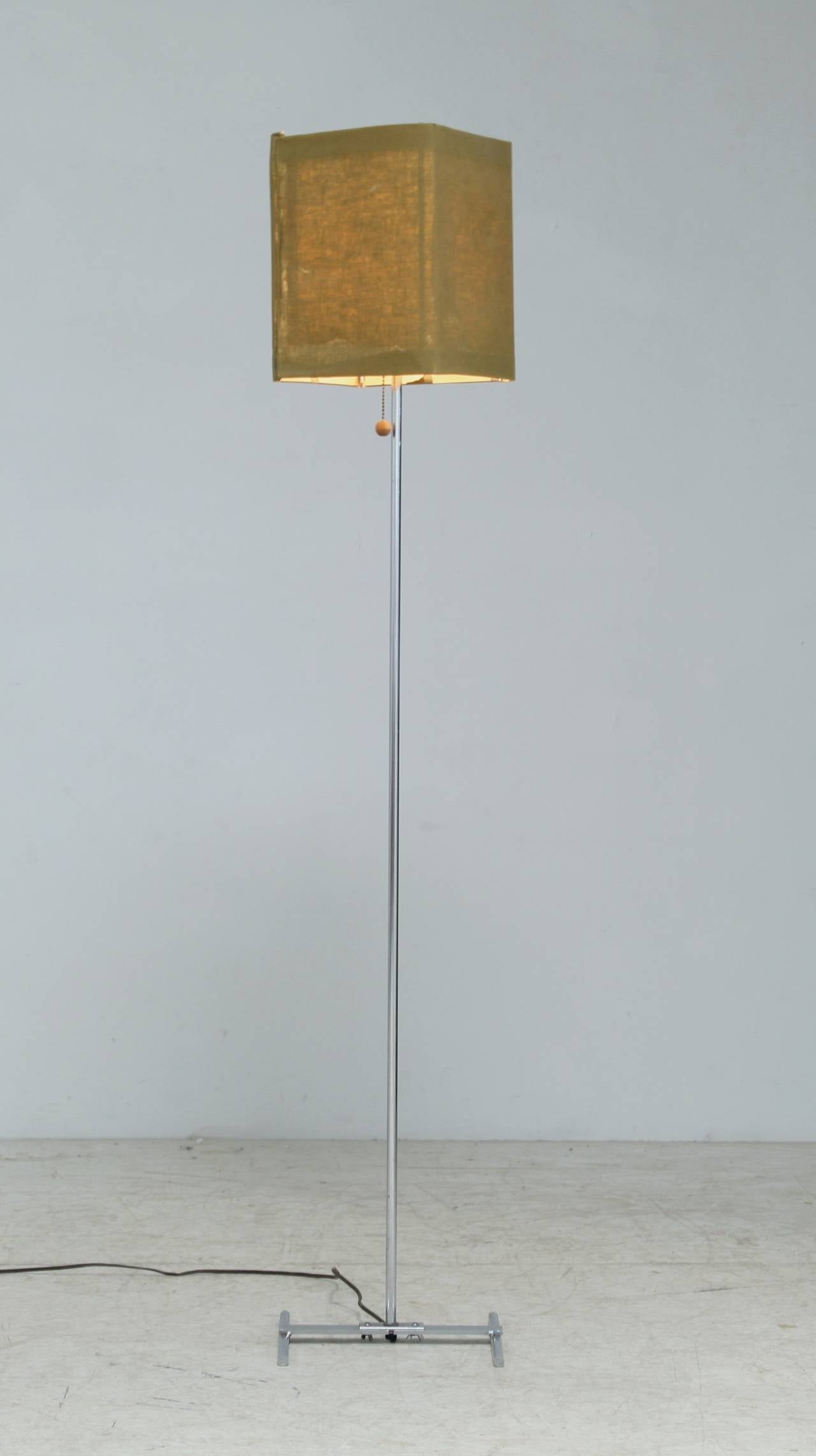 George Nelson floor lamp.
Chrome frame and a moss green square linen shade with a wood pull chain and pivot head.