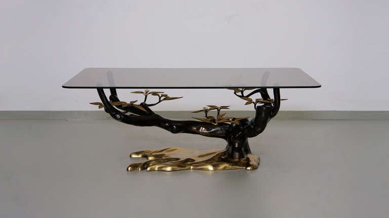 Rare brass coffee table attributed to Willy Daro with glass top and heavy brass base with natural leaf details. Excellent.