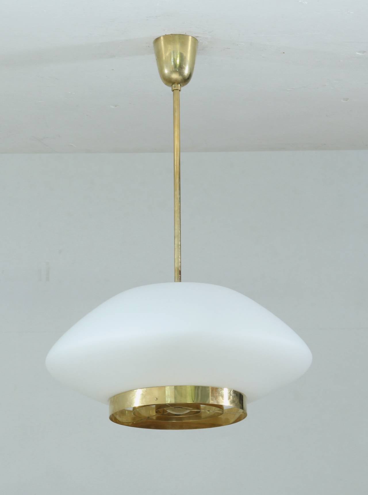 A perfect condition model 61-338 pendant lamp by Lisa Johansson-Pape for Stockmann Orno, made of opaline glass and a brass grid.