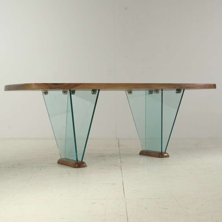 Beautiful desk designed and produced by Robert Sentou.
Robert Sentou produced for various designers, including Charlotte Perriand.

This desk has a thick solid table top in fruitwood and the glass legs are captured in wooden feet. Perfect