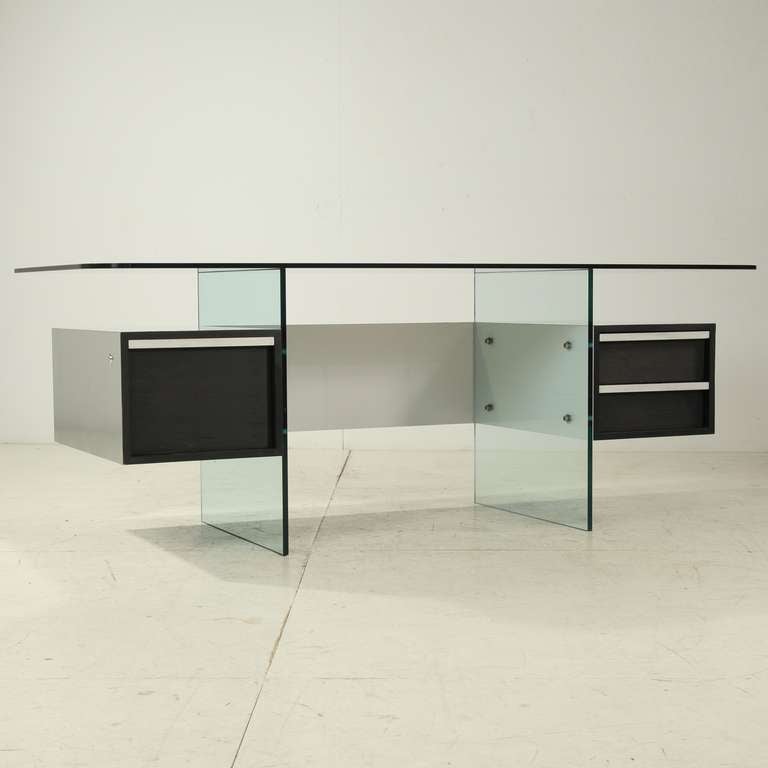 Elegant desk by French designer Xavier Marbeau. 
The desk is constructed from thick glass plates with formica, black stained oak  in an aluminium casting and  aluminium grips and stainless steel bolts. Excellent condition
This design of Xavier