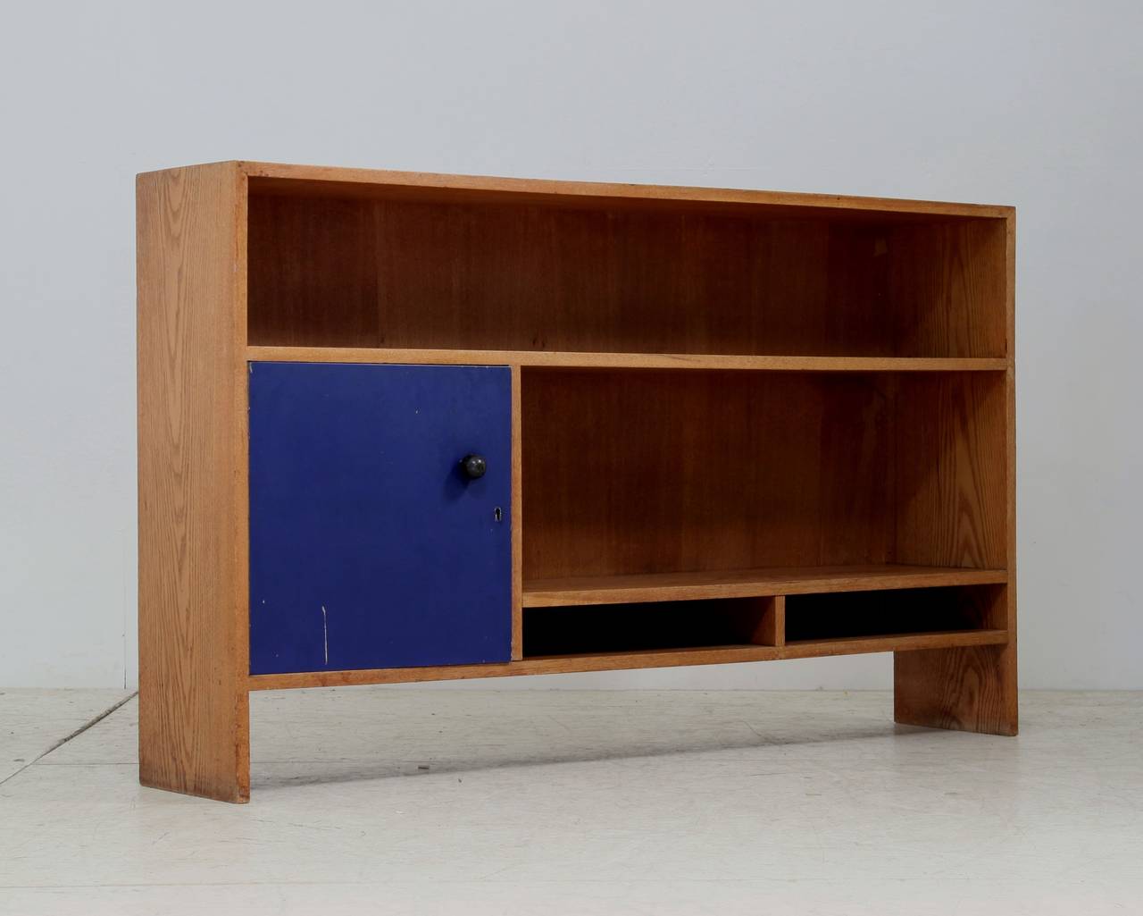 A rare bookcase by J.A. Muntendam, made of oak and a lacquered wooden door. The door still has the original blue paint.

It was custom-made for a school in Utrecht (the Netherlands). This piece comes from one of the former teachers of the school,