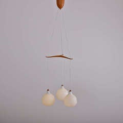 Triangle pendant lamp in glass and teak labeled  Luxus Sweden