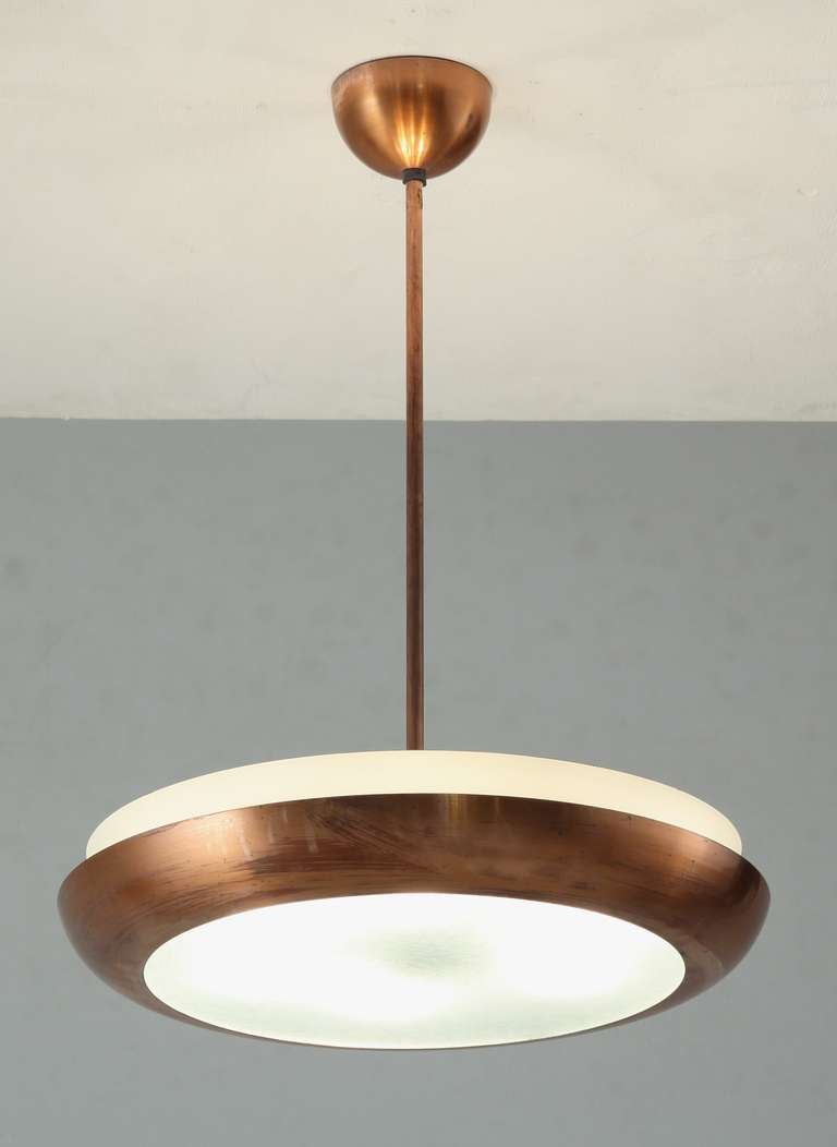 A copper coated ring with a glass diffuser plate and metal inner ring. The lamp holds six porcelain E27 lamp holders. Beautiful light, perfect for over a dining or kitchen table.