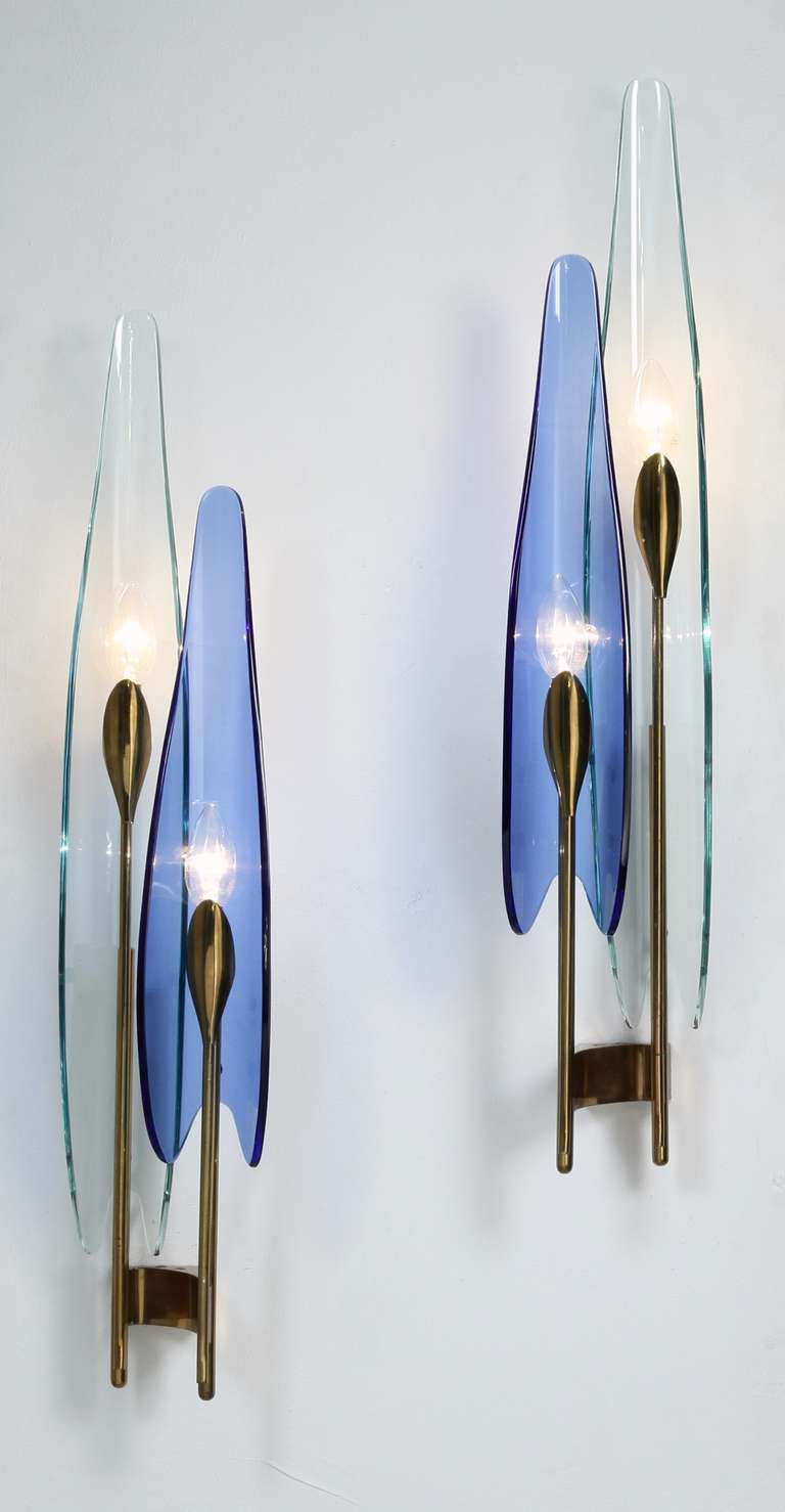 Wonderful pair of 'Dalia' wall sconces by Max Ingrand for Fontana Arte, Italy. These beautiful flower-shaped lamps are made of brass stems and glass petals in very pale aqua and blue. Exceptional beauty.

Both lamps are in a pristine and original