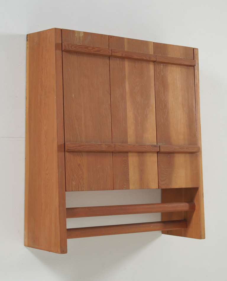 A wall cabinet in larch designed and used as a kitchen cabinet in Les Arcs 1600. Also very suitable as bathroom cabinet.  The cabinet holds three doors that tilt upward the cross bars below are ideal to hang towels. Provenance available.

Larger 4