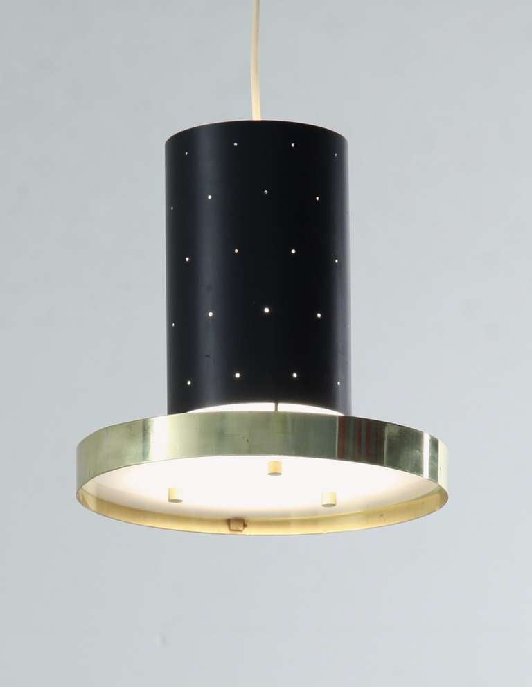A gorgeous small pendant in metal and brass, Finland, 1950s. The pinholes in the top cylinder and the copper ring with diffuser create a stunning light effect.

* This piece is offered to you by Bloomberry, Amsterdam *
