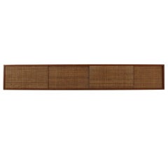 Floating Studio Line wall shelf with jute covered sliding doors