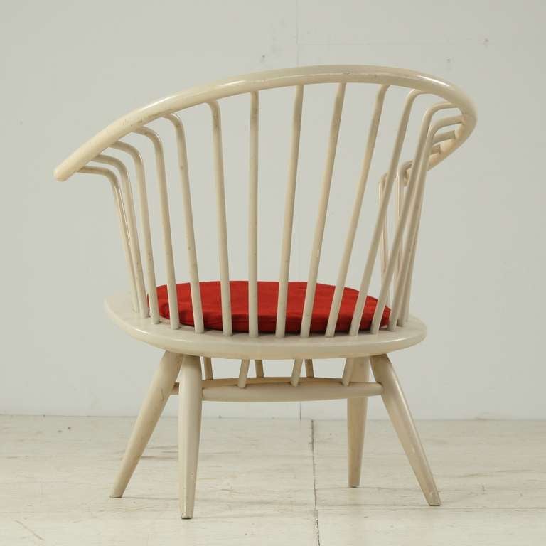 Off-white Crinolette chair by Ilmari Tapiovaara for Asko. The chair is labeled and holds the original red seat pad. Perfect structural condition with wear consistent with age.