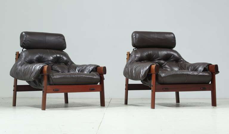 Pair of Percival Lafer lounge chairs with removable headrest. Rosewood with dark brown leather seating.