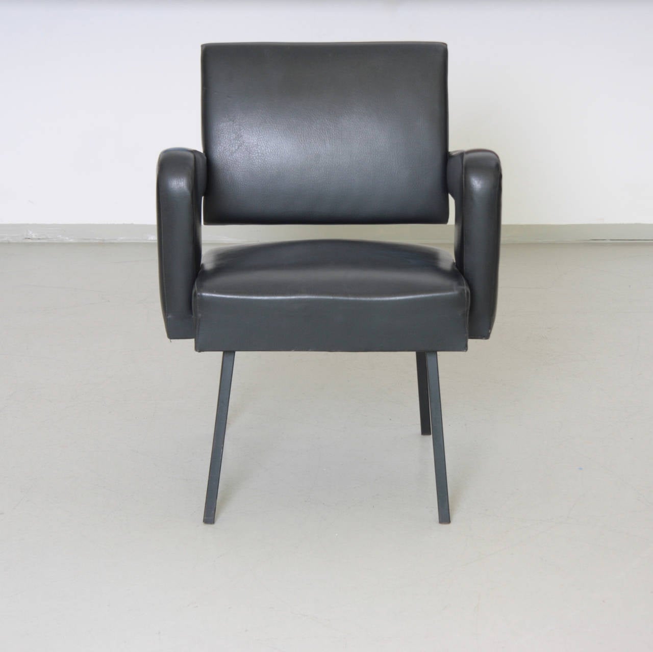 This chair was produced 1958 for the CEA (Comissariat l`Energie Atomique) by Jacques Adnet. That chair was located at the DAM (Direction des' Applications Militaires) in the Paris region. See label!

The chair is published in the Jacques Adnet