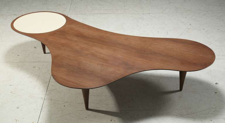 Very large free form coffee table in walnut
The table has a white formica circular inlay and tapering legs