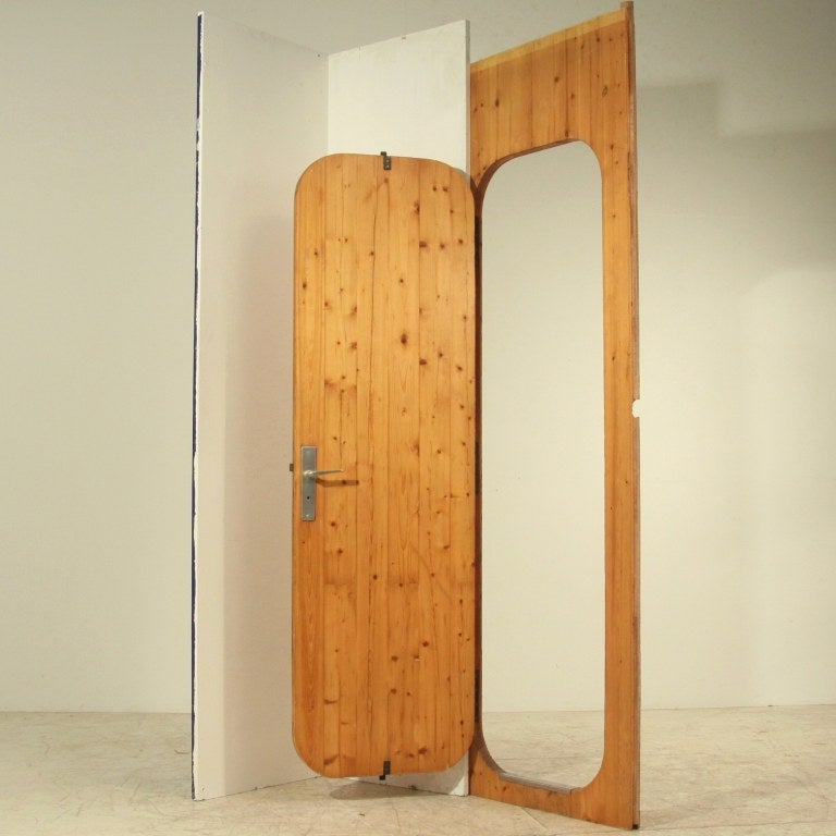 A Charlotte Perriand door from the Arc 1600 ski resort in Les Arcs (1967-1969), built by a team of architects, including Perriand. 
Wonderful framed door with rounded corners in pine. From the pencil marks we can tell it was the door between the