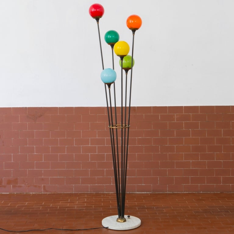 Colourful Stilnovo floor lamp, Italy, 1950s. Five arms topped with colourful glass balls. Arms are based on a white marble foot and held together by a brass ring.
Excellent condition.