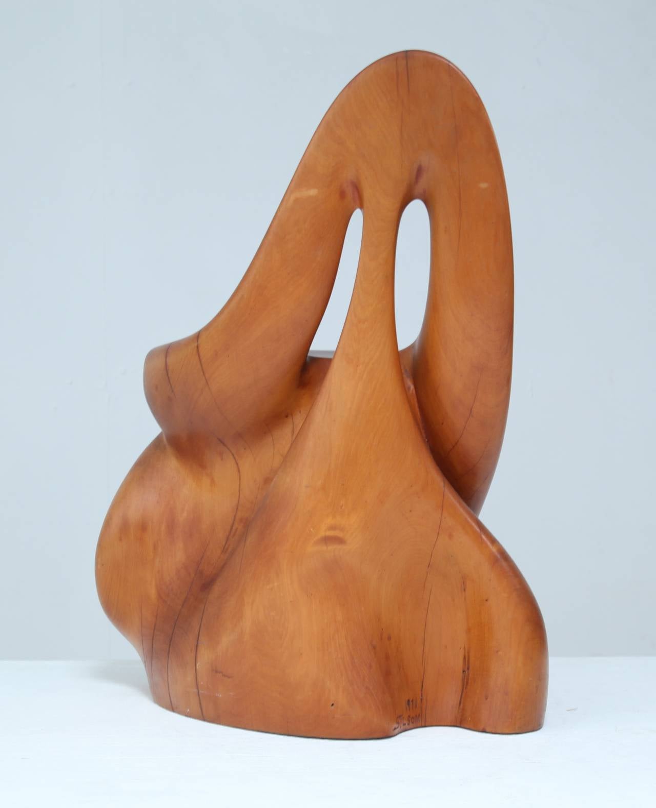 A small, highly sculptural stool or children's chair, shaped like a tree trunk. This unique piece is made of New Zealand kauri wood and is both a rustic looking chair and a beautiful object.