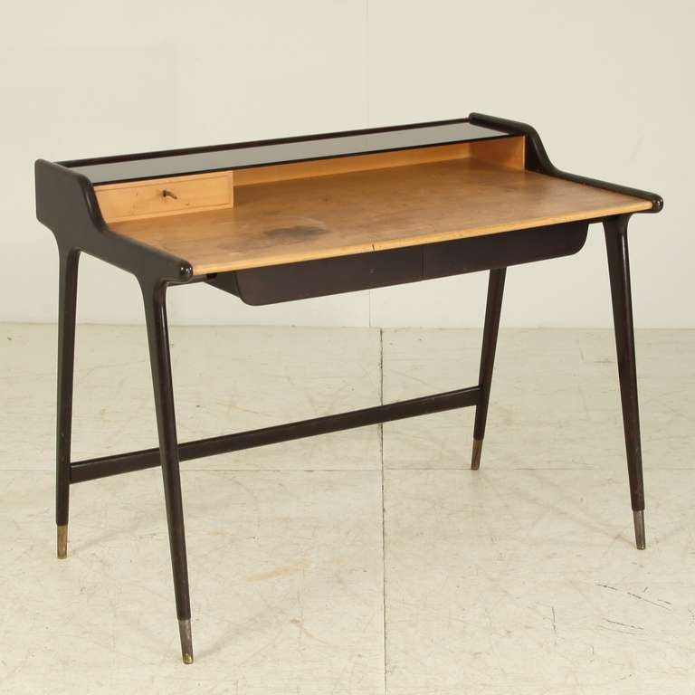 Elegant ladiesdesk. Black ebonized beech with brass feet by German Architect Reinhold Stotz.
Two large drawers and a small drawer at the top, covered by the full lenght small dark glass plate.
published in 