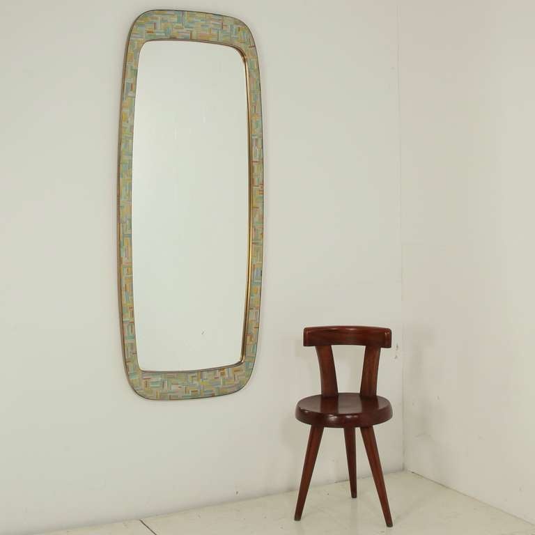 The mirror has a double brass frame. inlay with pale pastel mosaic glass tiles. 

Branded Waldemar Schuster at the back. 

No wear to the mirror glass or the tiles, brass has beautiful patina