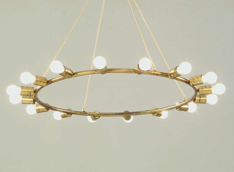 Mid-20th Century A large and minimalistic brass circular chandelier