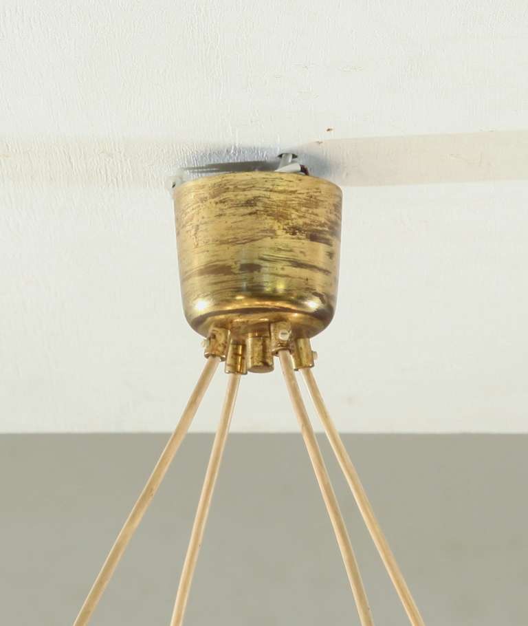 A large and minimalistic brass circular chandelier 2