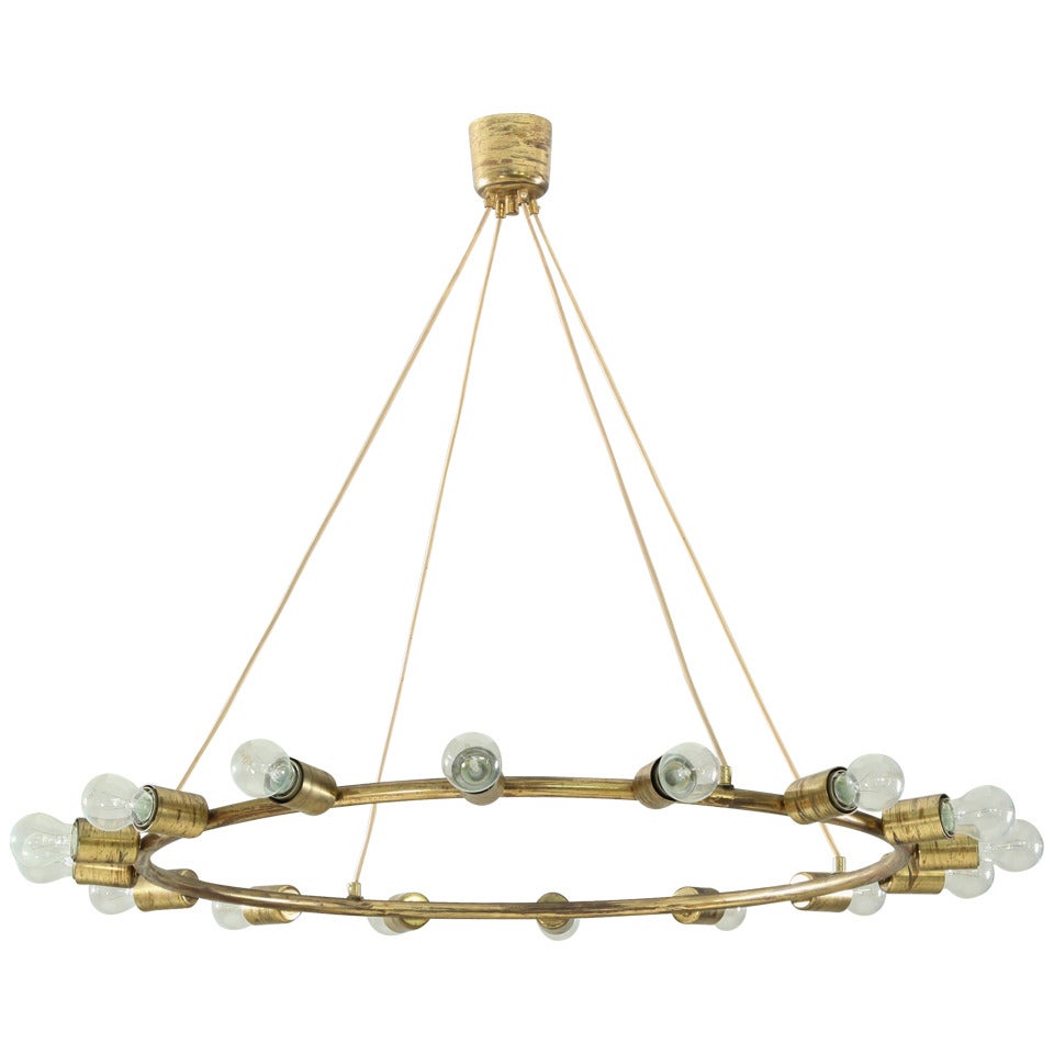 A large and minimalistic brass circular chandelier