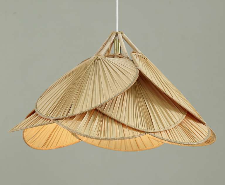 A pendant lamp made of a light bulb covered by twelve 'leaves' made of rattan and Japanese paper.