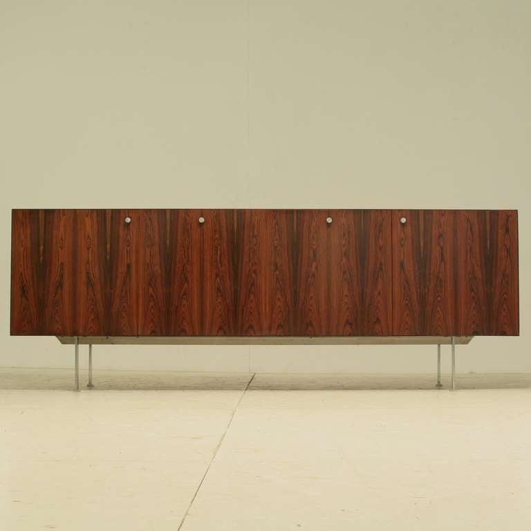 Large 1960s  credenza by Poul Nørreklit, Denmark,1960s.
The doors are  facet cut on the inside, like the brass slides for the drawers, these are examples of the stunning quality of this credenza.
Six drawers on the inside to the right and the