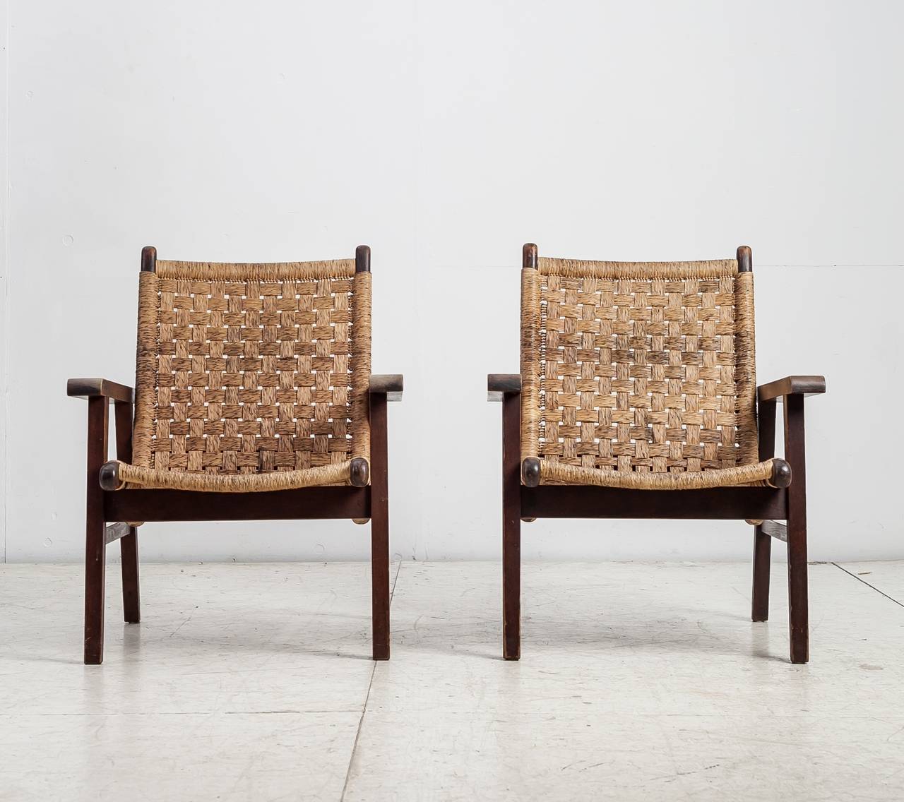 A pair of Mexican lounge chairs with woven cord seating, attributed to Michael van Beuren.
They have a wonderful patina and are in an excellent condition.

American-born, Bauhaus-trained Michael van Beuren moved to Mexico in 1937, where he