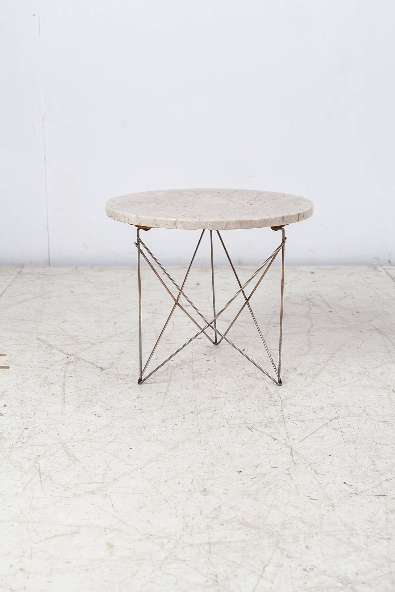 A Rene Brancusi side or coffee table made of a brass wire frame and an Italian marble top.